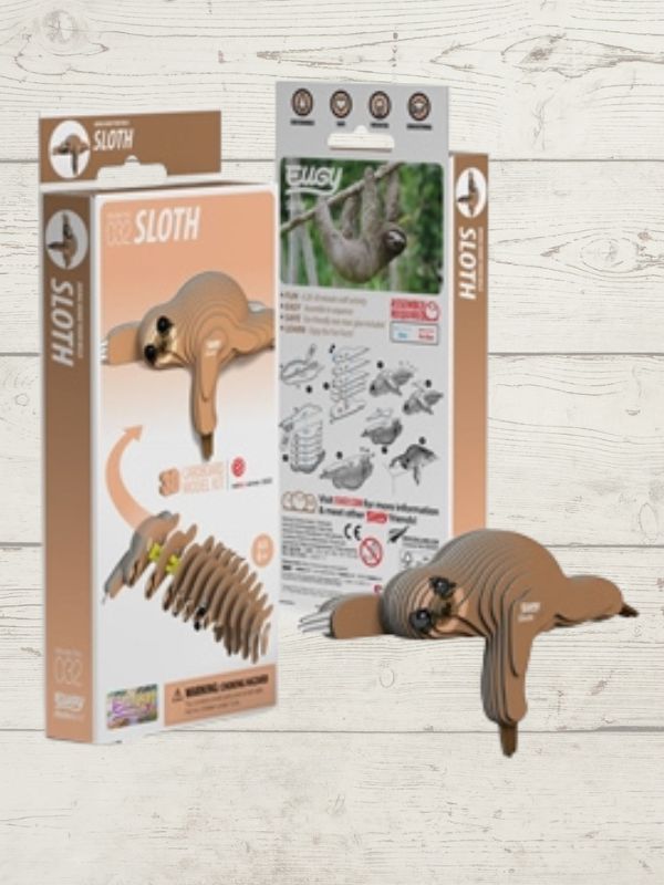 Sloth toy with packaging on a wooden surface