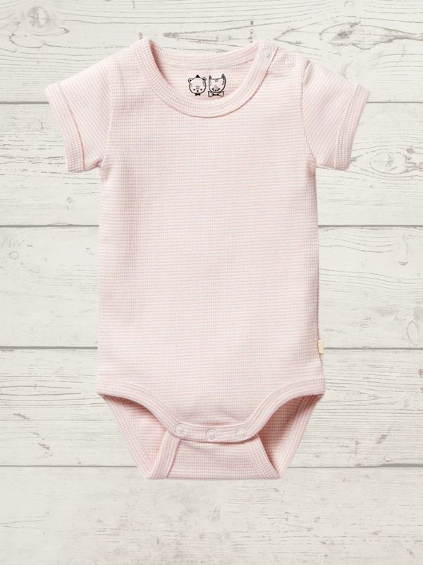 A pink short-sleeve rib bodysuit for babies, with a round neckline and side snap opening, displayed on a wooden background.