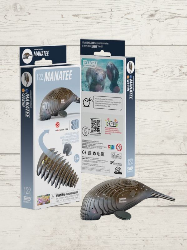 A 3D puzzle model of a manatee, presented next to its packaging which includes brand and product information.