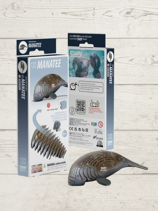A 3D puzzle model of a manatee, presented next to its packaging which includes brand and product information.