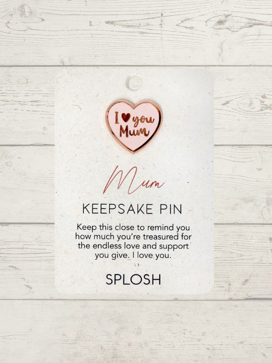 heart shape keepsake pin in pink on a card on a wooden surface
