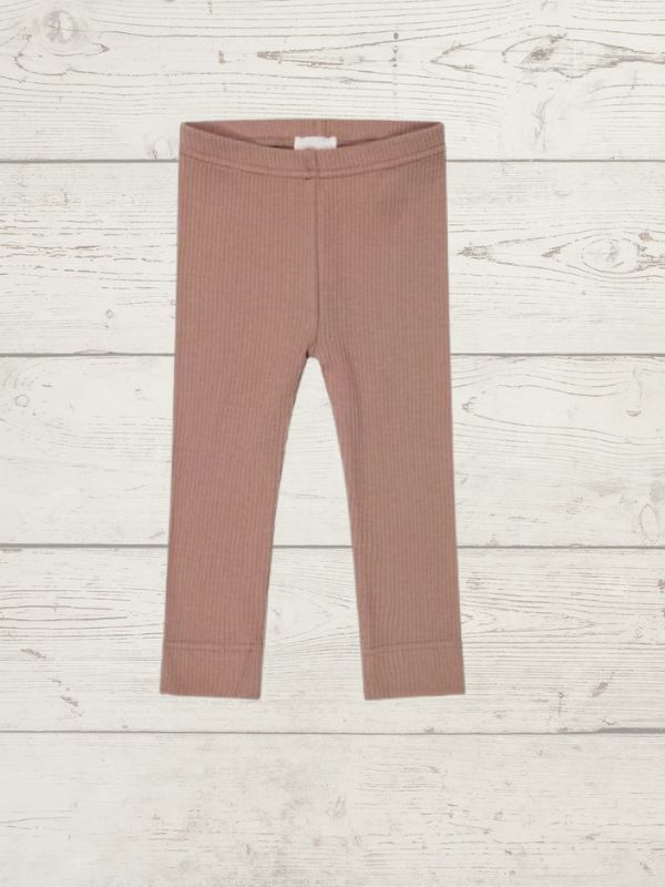 a pair of childrens leggings on a wooden surface