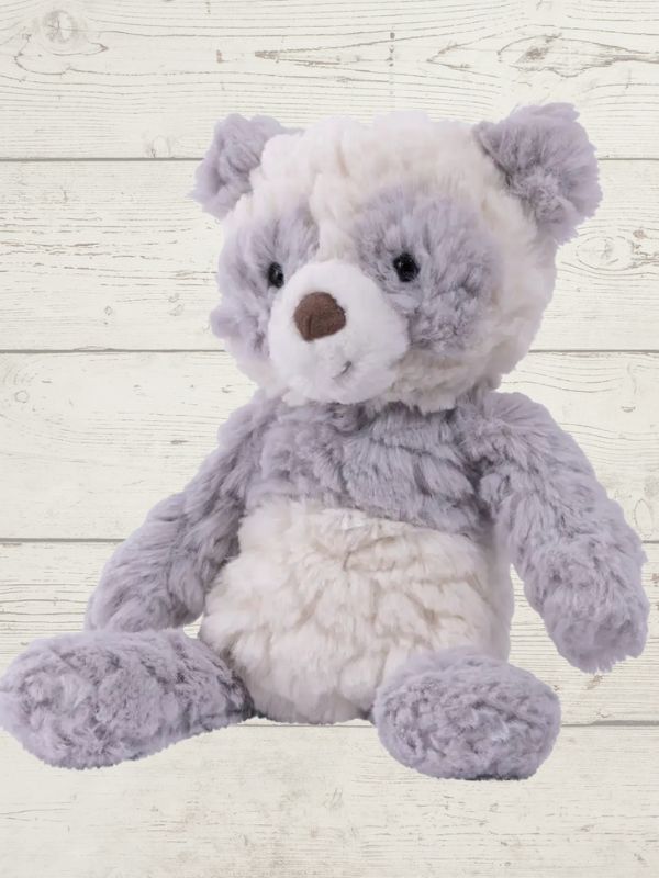 plush panda sitting on a wooden surface