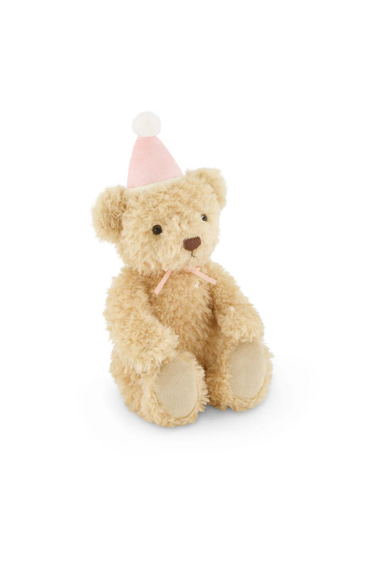 Teddy bear wearing a pink party hat on a white background