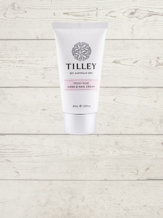 A tube of Tilley hand and nail cream against a white wooden background.