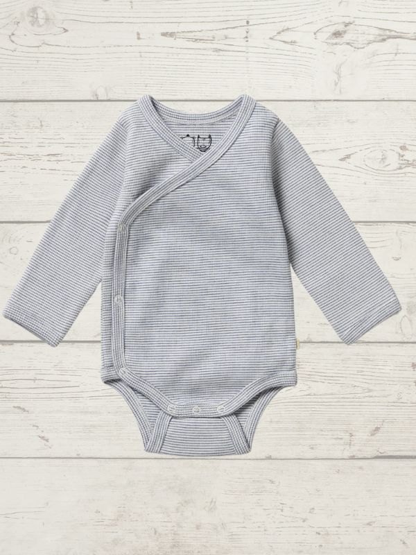 A blue long sleeve rib kimono bodysuit for babies, with a cross-over neckline and snap opening, displayed on a wooden background.