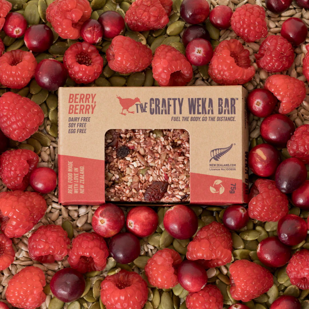 The Crafty Weka Bar package surrounded by raspberries and cranberries
