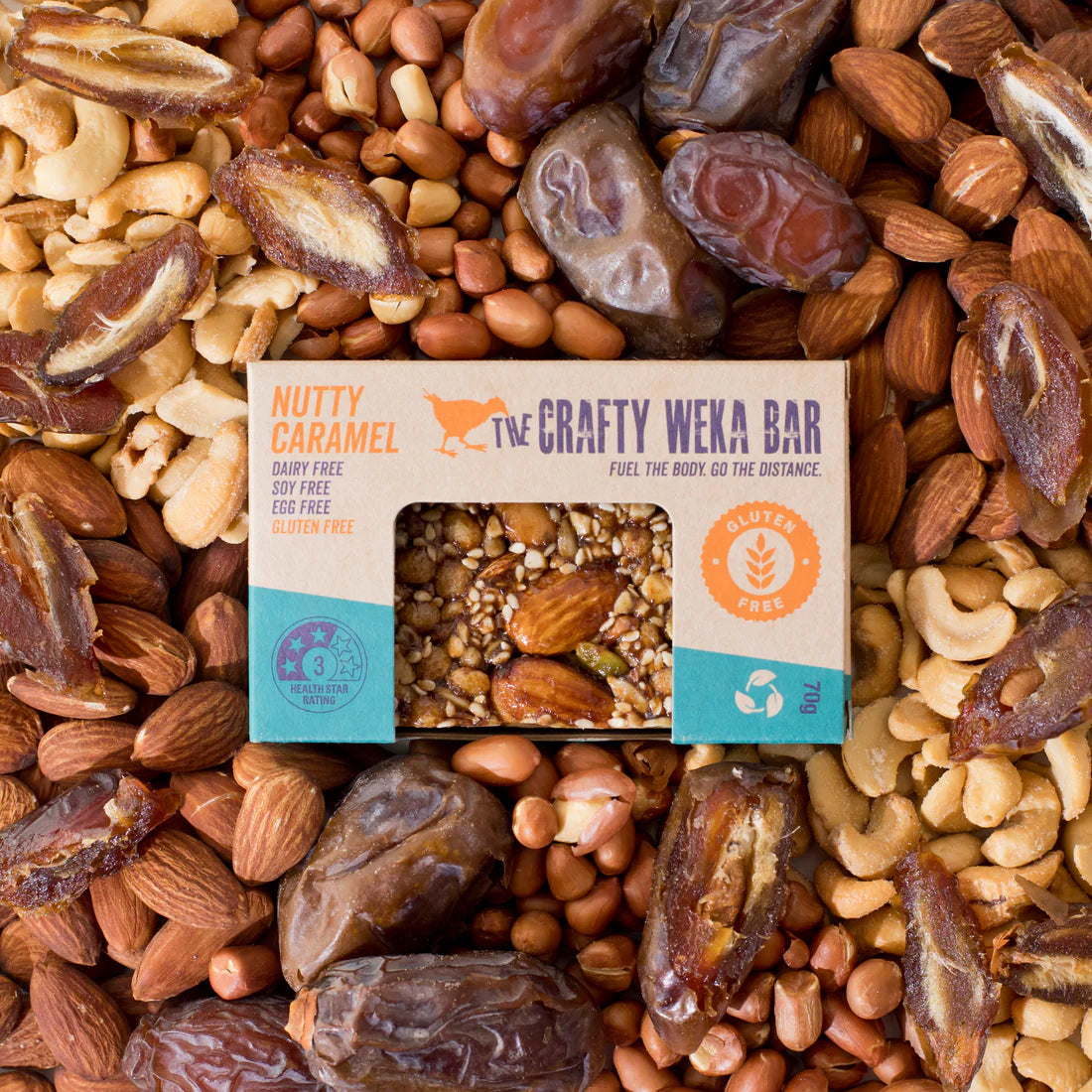 The Crafty Weka Bar surrounded by a mix of nuts and dates