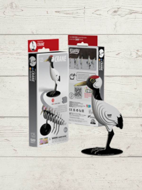 Bird puzzel with packaging on a light wooden surface