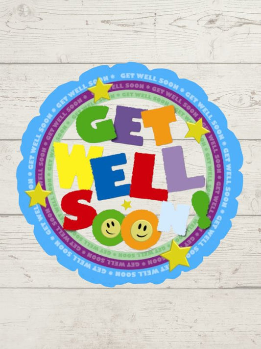 A round balloon with 'GET WELL SOON' text in colorful letters, surrounded by stars and a smiley face on a wooden background.