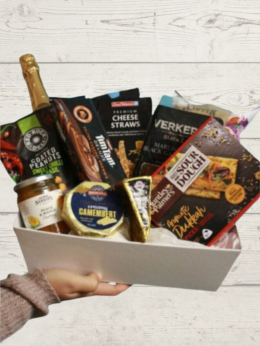 gift box of gourmet treats including cheese, relish, crackers, nuts and biscuits