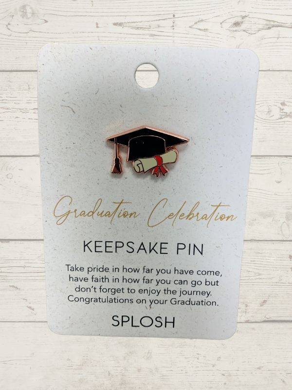 A keepsake pin with a graduation celebration theme, featuring a rose gold-colored graduation cap on a card with the text 'Graduation Celebration Keepsake Pin' and 'SPLOSH' branding.