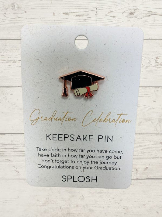 A keepsake pin with a graduation celebration theme, featuring a rose gold-colored graduation cap on a card with the text 'Graduation Celebration Keepsake Pin' and 'SPLOSH' branding.