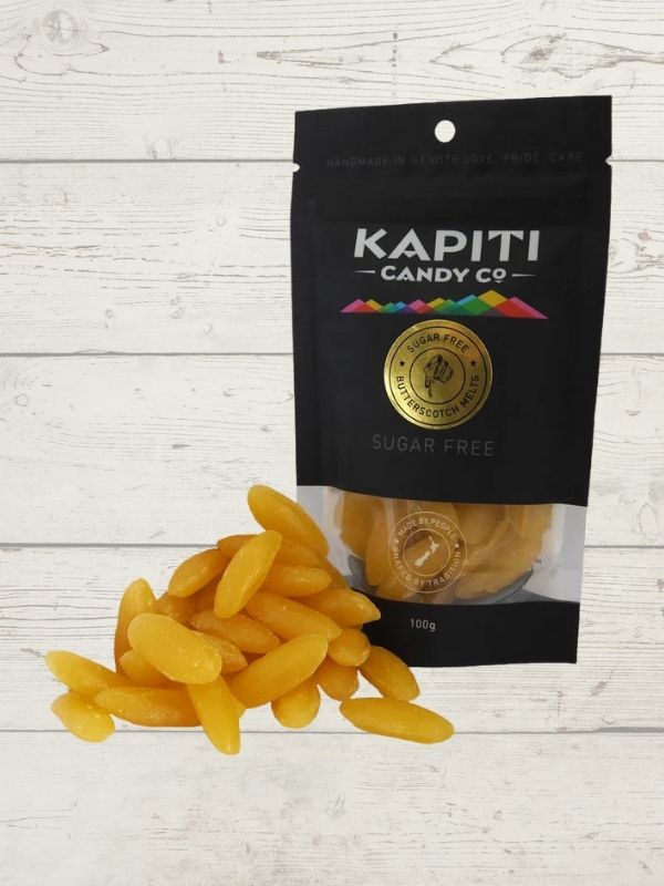 Kapiti Candy Co. package with yellow candy on a light wooden surface
