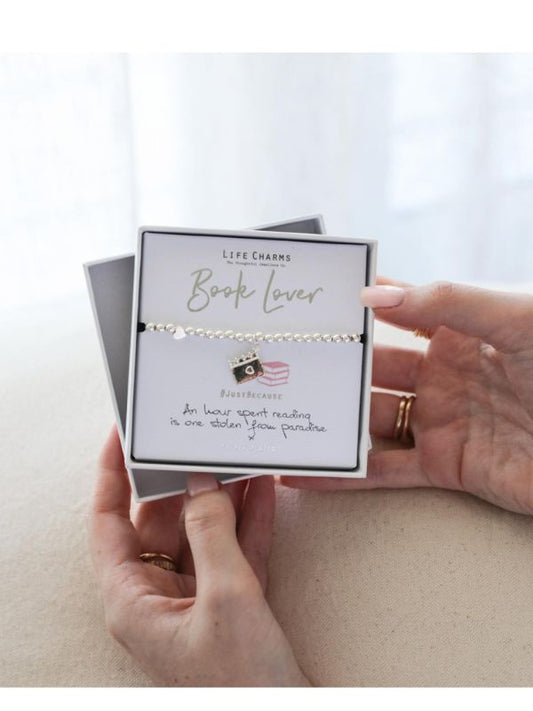 Jewelry card with 'Book Lover' necklace and holder on a light background