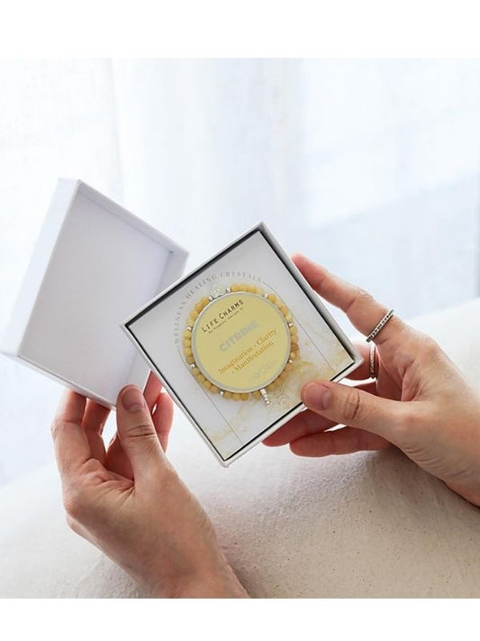 Person holding a boxed bracelet