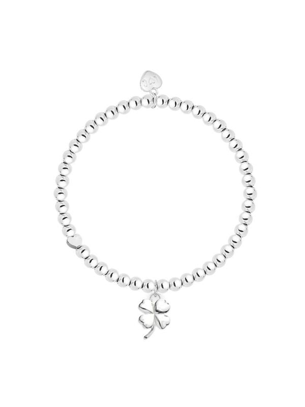 Silver bracelet with a clover charm on a white background