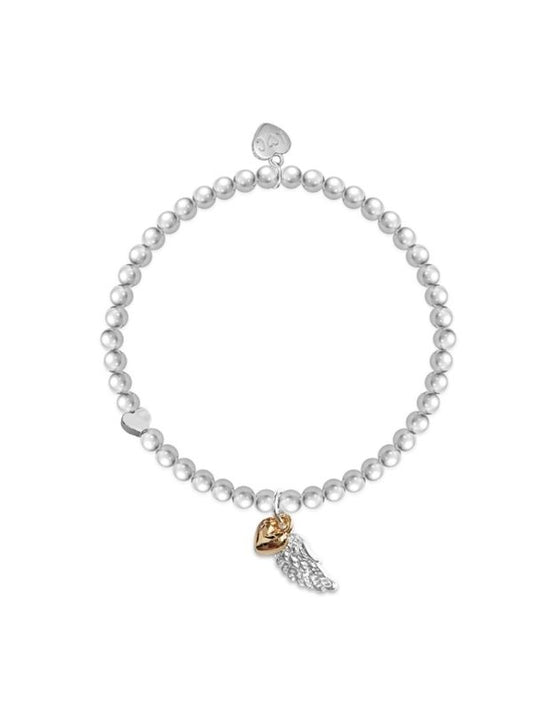 Pearl bracelet with a gold and silver charm on a white background