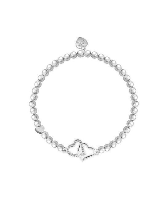 Pearl bracelet with silver heart charms on a white background