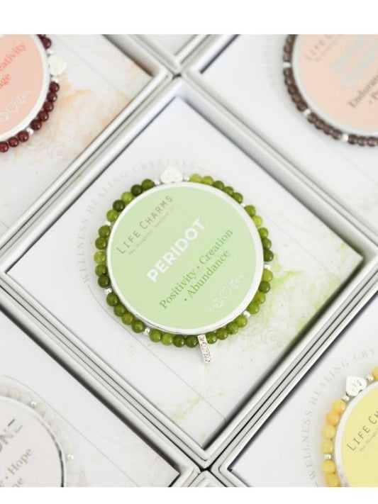 Green beaded bracelet in a box with 'Life Currents' branding