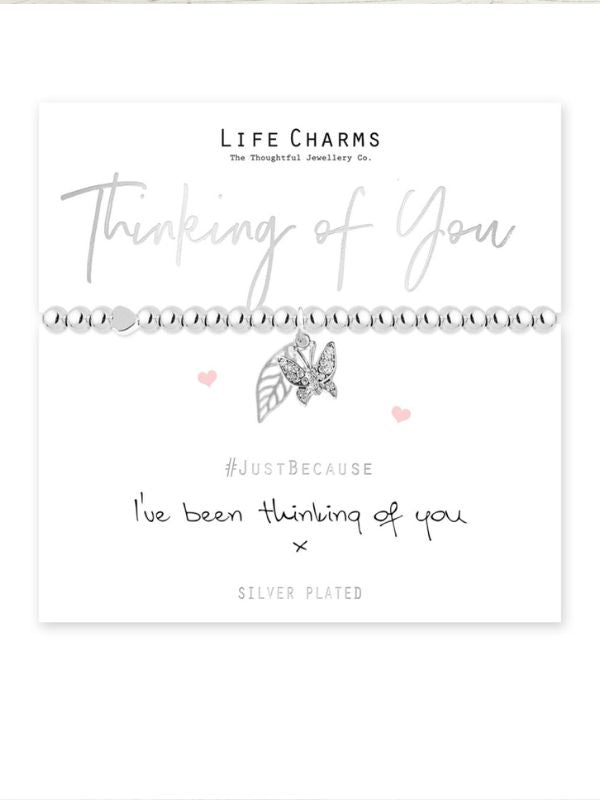 Jewelry card with two silver bracelets and decorative text on a white background