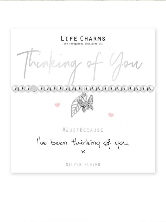 Jewelry card with two silver bracelets and decorative text on a white background