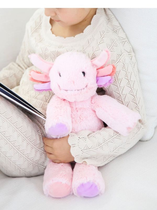 Person holding a pink plush toy with a neutral background