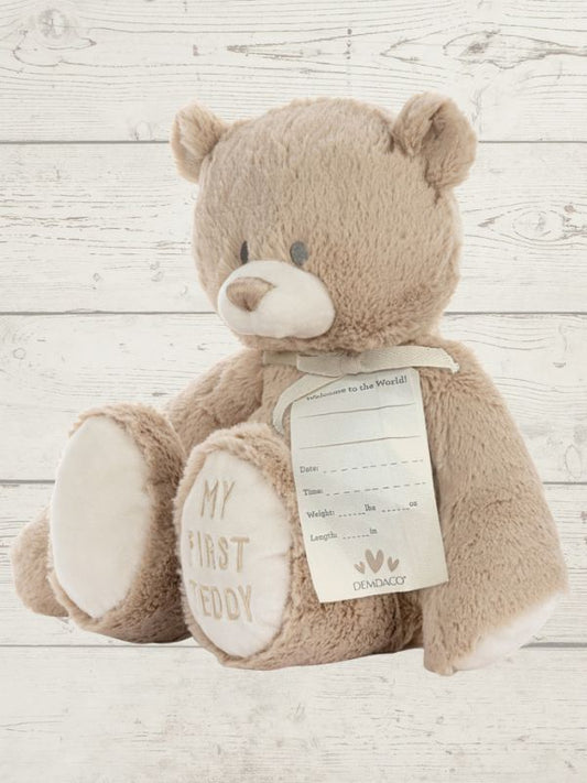 Teddy bear with a tag on a wooden surface