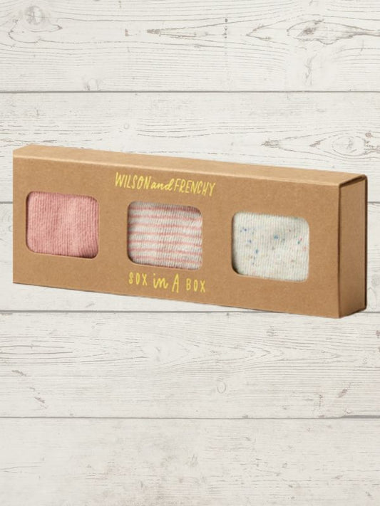 Box of socks with 'Wilson and Frenchy' branding on a wooden surface