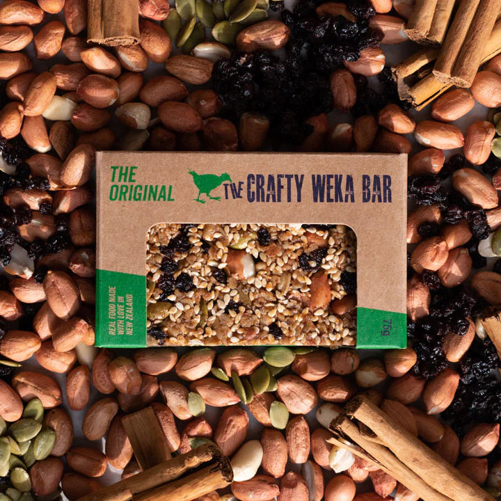 Crafty Weka Bar packaging surrounded by nuts and seeds