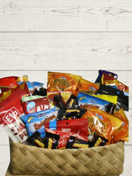 A wicker basket filled with a variety of snack items, such as chips and candy, packaged in individual bags.