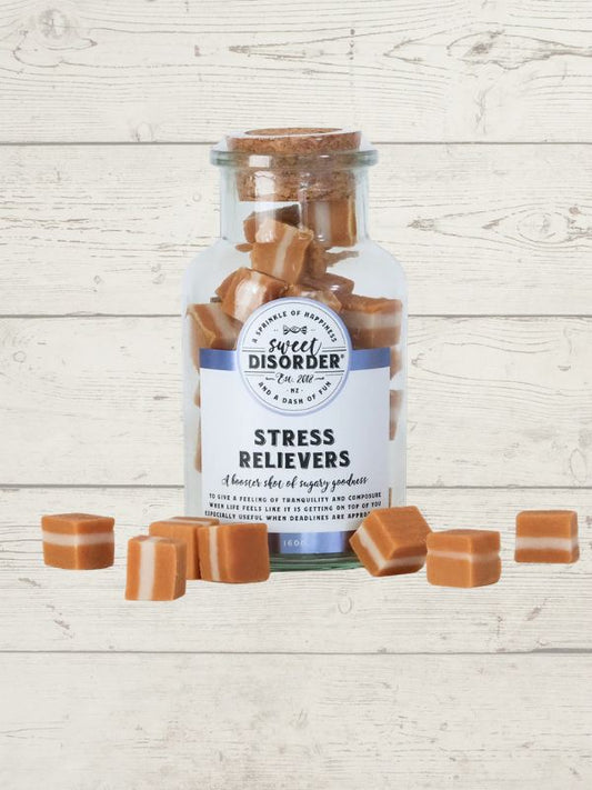 Jar labeled 'Sweet Disorder' with caramels on a wooden surface