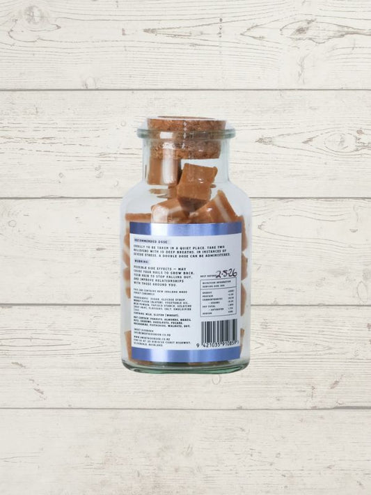 Glass jar with a label on a wooden surface