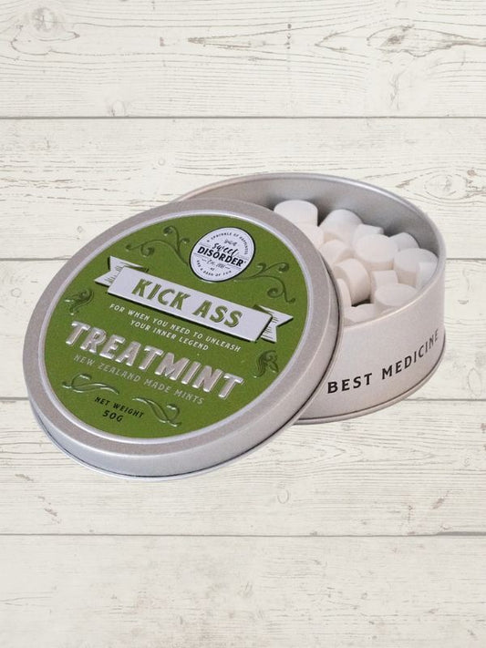 Tin of mints with a humorous label on a wooden surface