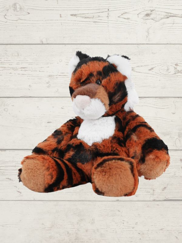 Plush tiger toy on a light wooden surface