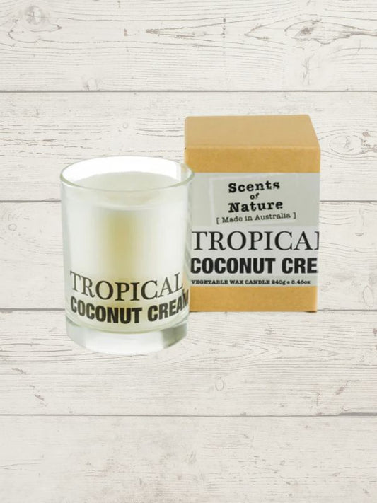 Tilley scented candle coconut cream displayed in a glass jar with packaging on a white wooden background.