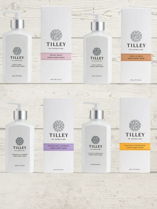 A collection of Tilley body wash bottles in various scents, including lavender, vanilla, and patchouli, with packaging that displays the scent name and minimalist design.