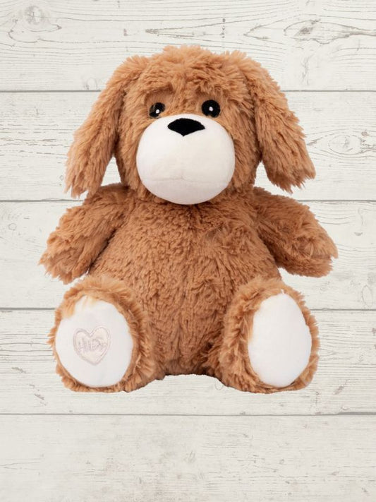 Brown plush dog toy on a light wooden surface