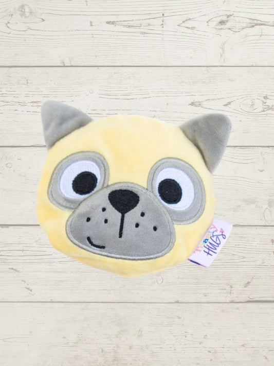 Plush toy with a dog face design on a wooden surface