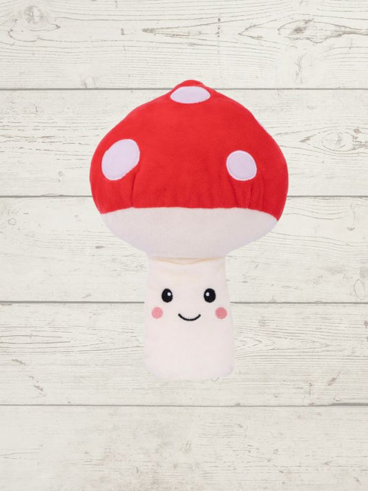 Plush toy mushroom with a red cap and white body on a light wooden background