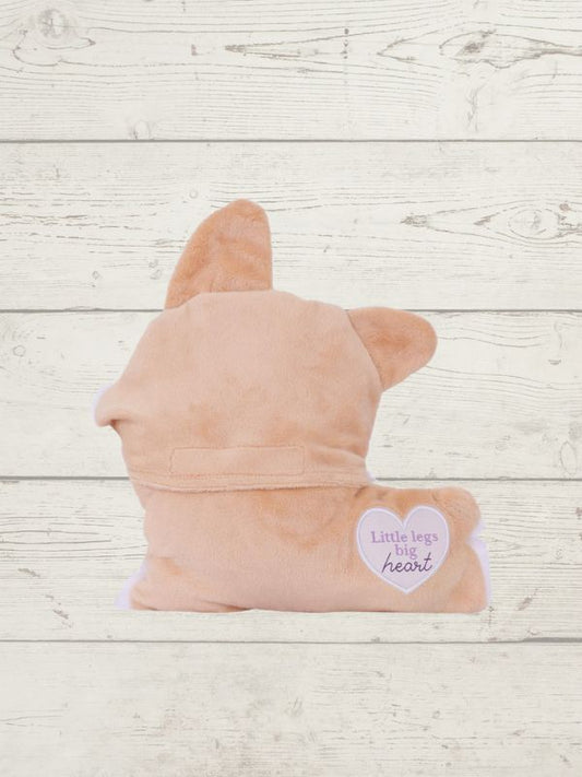 Pink plush toy shaped like a dog on a wooden surface with a heart-shaped tag.