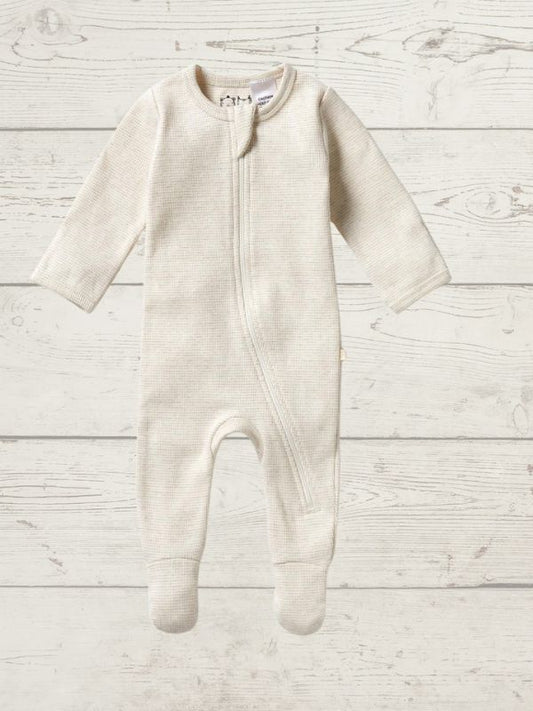 A long sleeve rib zipsuit for babies, with feet and fold-over mittens, in a gray color, displayed on a wooden background.