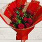 12 red roses with foliage wrapped in red and pink paper 