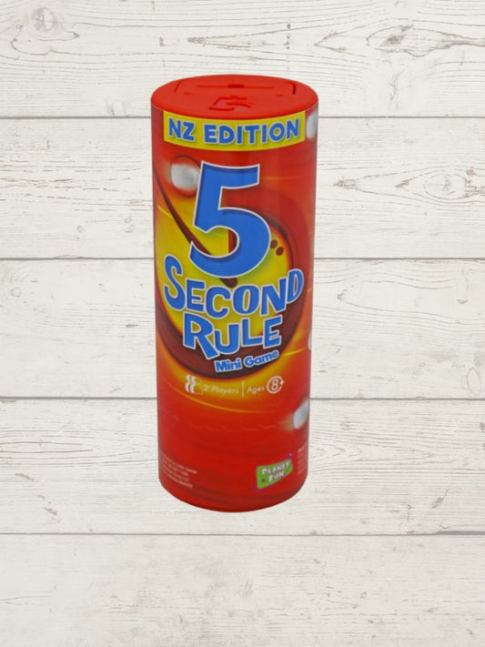  mini version of the 5 Second Rule game displayed with a red cylindrical timer, yellow spiral timer, and several question cards laid out on a wooden surface.