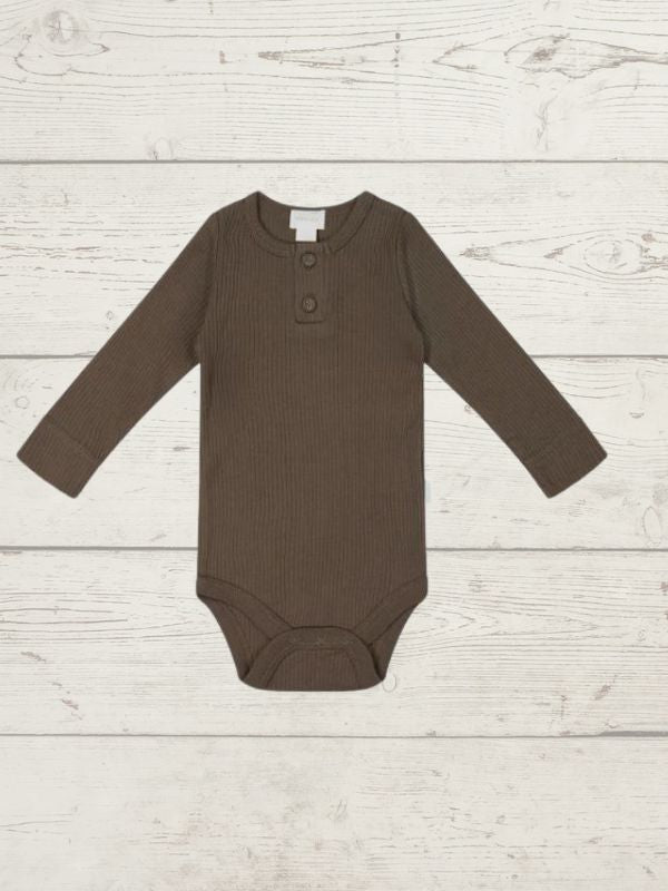 A long sleeve brown bodysuit for babies, laid out flat on a wooden surface.
