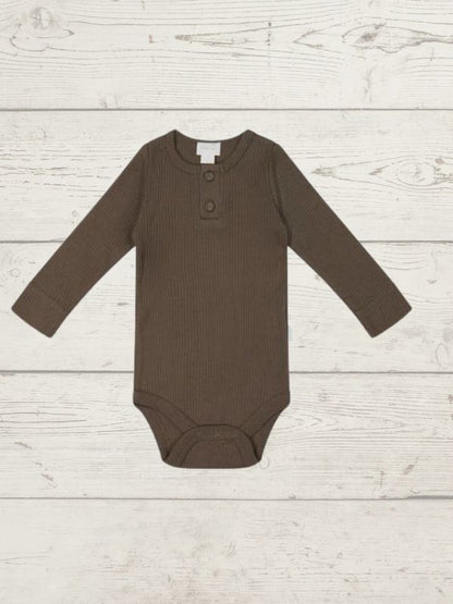 A long sleeve brown bodysuit for babies, laid out flat on a wooden surface.