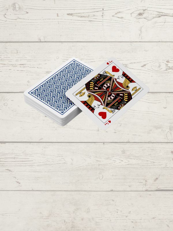 deck of cards showing the Joker of hearts on a wooden surface