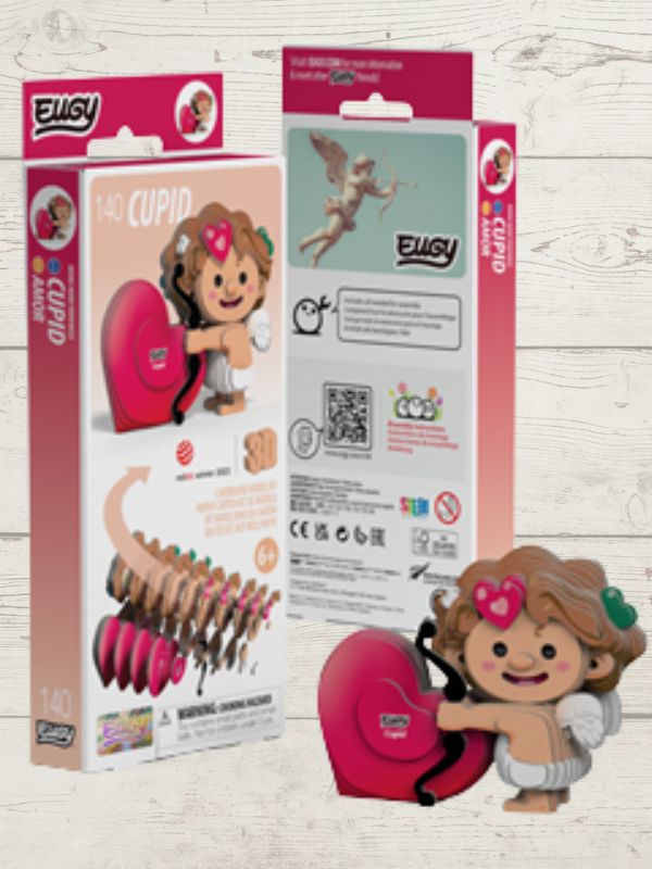Toy figure of a Cupid character with packaging on a wooden surface