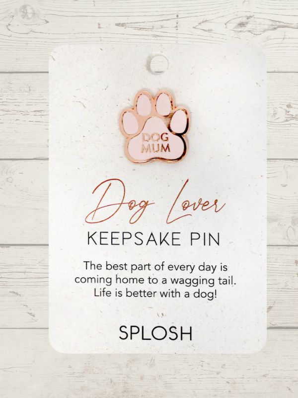 A rose gold keepsake pin in the shape of a dog's paw with the text 'DOG LOVER' and a heartfelt message.
