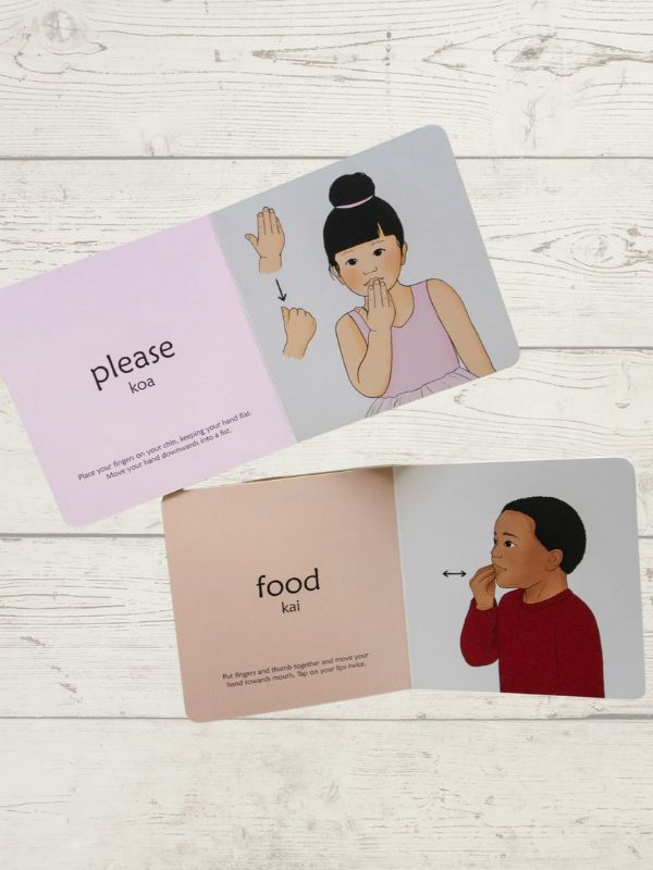 2 opened book showing 2 children showing sign for Please and Food on a wooden background